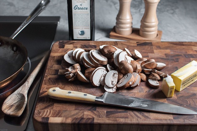 Preparing mushrooms for sautéing, sliced and ready in a bowl