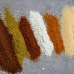 Close up of homemade taco seasoning in a glass jar, showcasing the vibrant blend of spices ready to enhance your taco night.