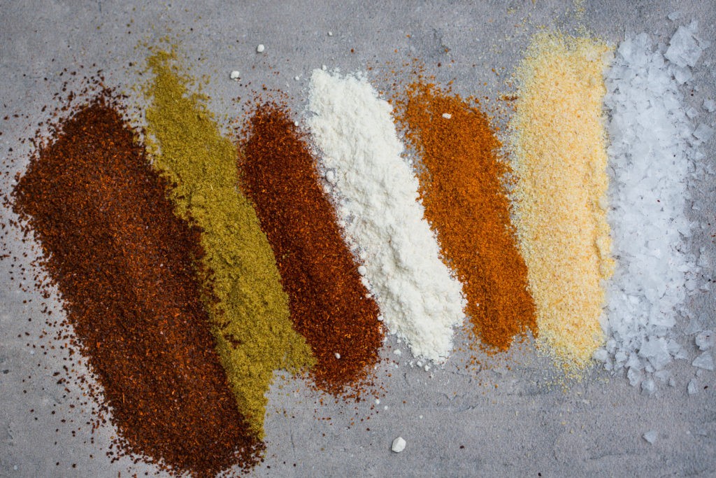 Close up of homemade taco seasoning in a glass jar, showcasing the vibrant blend of spices ready to enhance your taco night.