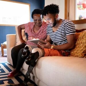 A mother and son looking at a tablet, representing online SSI application accessibility