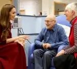 PA Media The Princess of Wales speaks to an elderly man and woman who are smiling as they talk with the princess inside the Royal Marsden Hospital