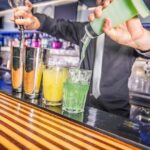 Bartender pouring alcohol from a bottle