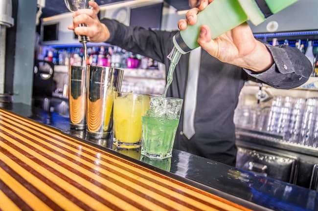 Bartender pouring alcohol from a bottle