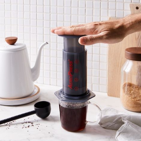 Close-up of coffee beans being ground in a burr grinder