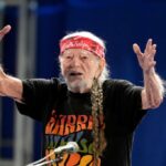 Willie Nelson blows a kiss to the crowd after performing at a Vice President Kamala Harris rally