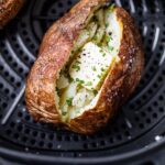 Perfectly cooked air fryer baked potato with fluffy inside