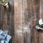 Baking scene with flour, eggs, and kitchen utensils, illustrating the need for accurate measurements in recipes.