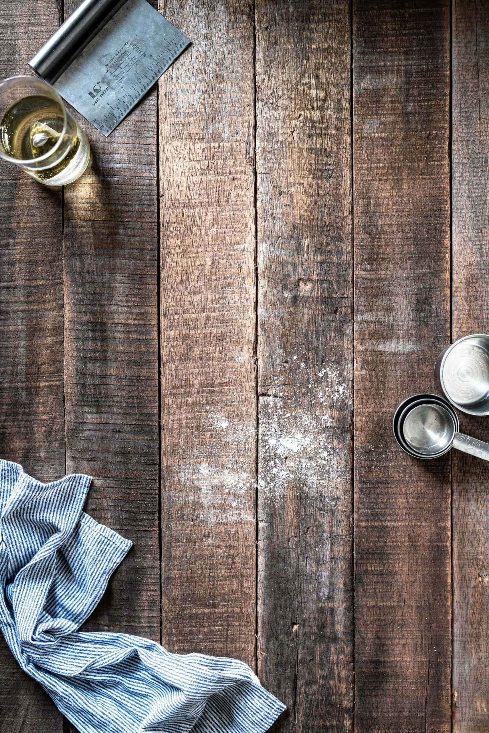 Baking scene with flour, eggs, and kitchen utensils, illustrating the need for accurate measurements in recipes.