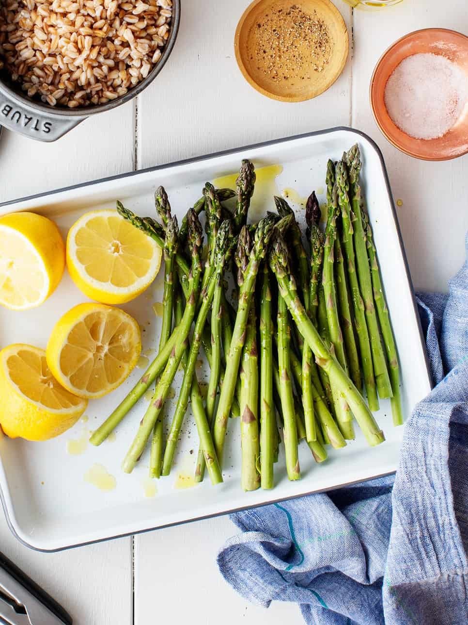 Overhead shot of roasted asparagus on a baking sheet, golden brown and crisp, ready to be served as a healthy side dish.