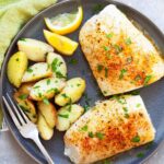 Baked cod served with boiled potatoes, highlighting a simple and healthy meal idea.