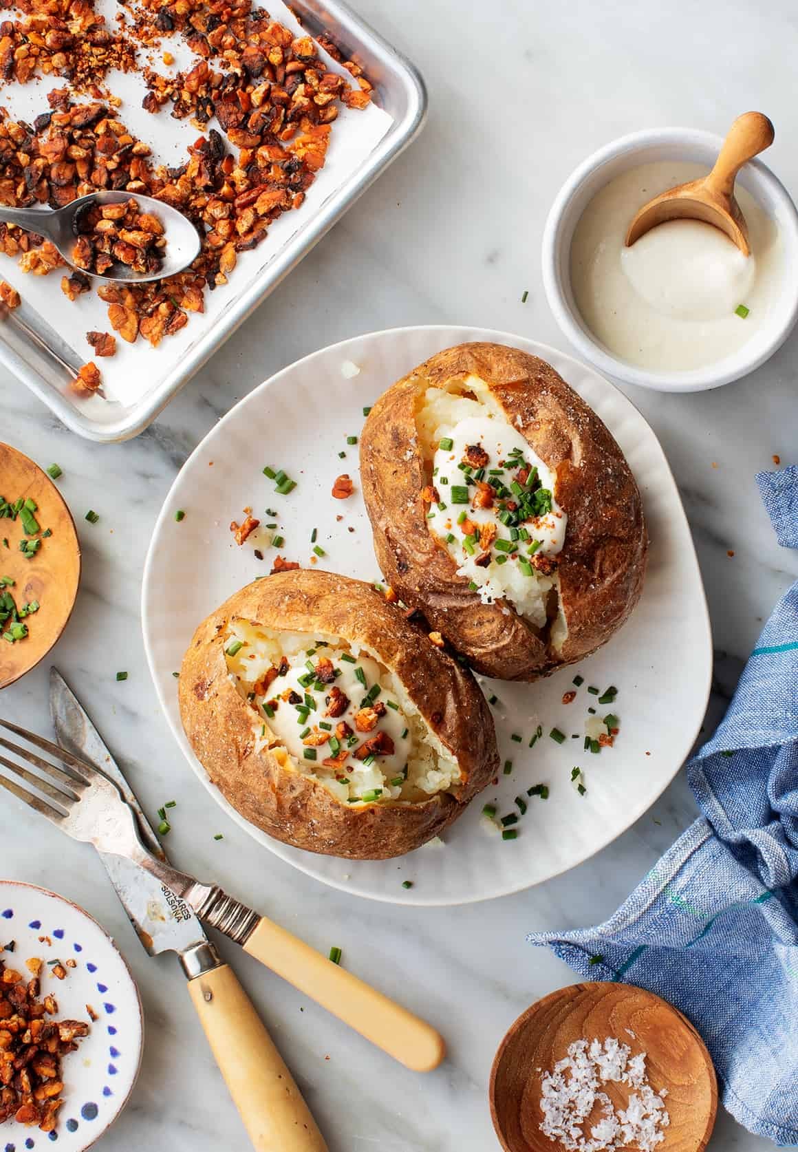 Close-up of a baked potato with crispy skin, ready to be served.