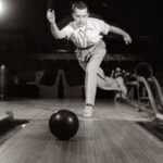 Vintage man playing bowling ball.