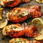 Lobster tails broiled on a sheet pan.