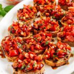 Close-up of fresh tomato and basil bruschetta, showcasing vibrant colors and textures.