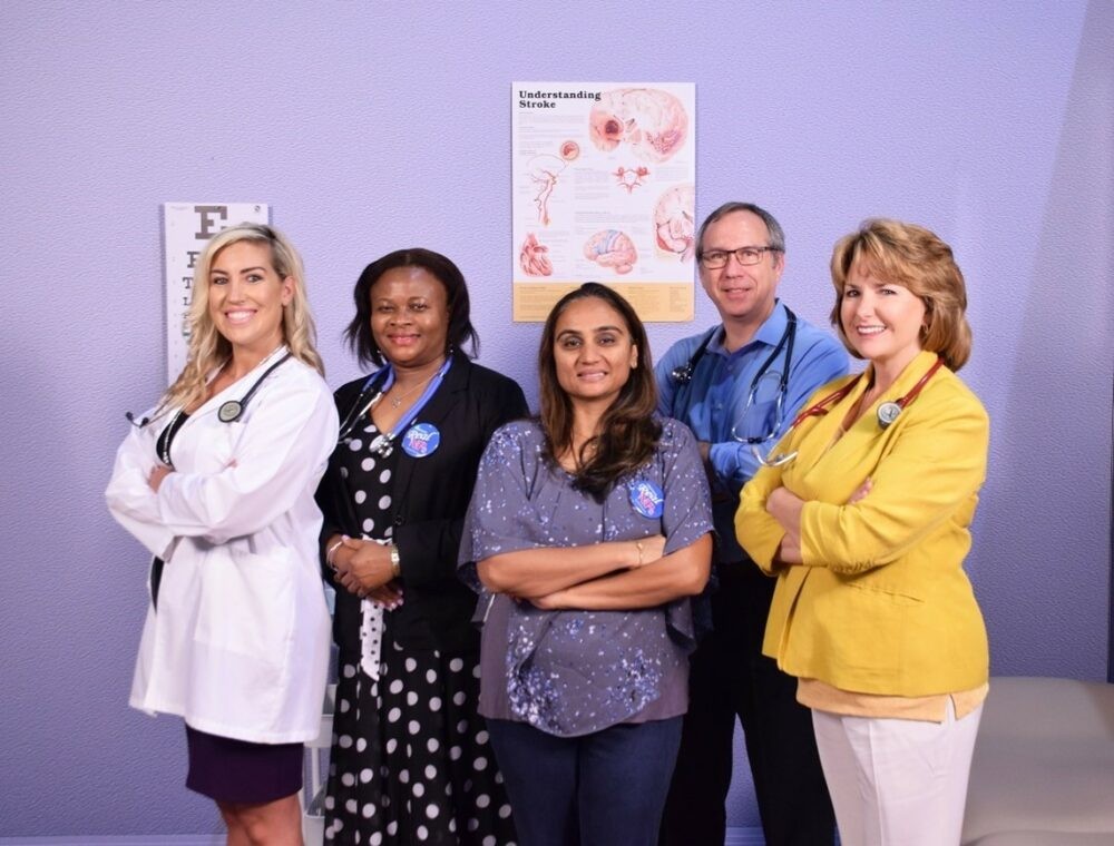 A diverse group of Nurse Practitioners collaborating in a hospital setting, showcasing the teamwork and patient care in NP practice.