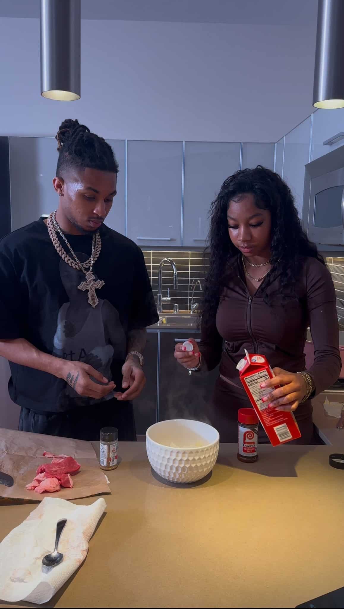 Cooking with Kya, a TikTok food creator, poses with rapper DDG, highlighting her broad appeal and influence in popular culture.