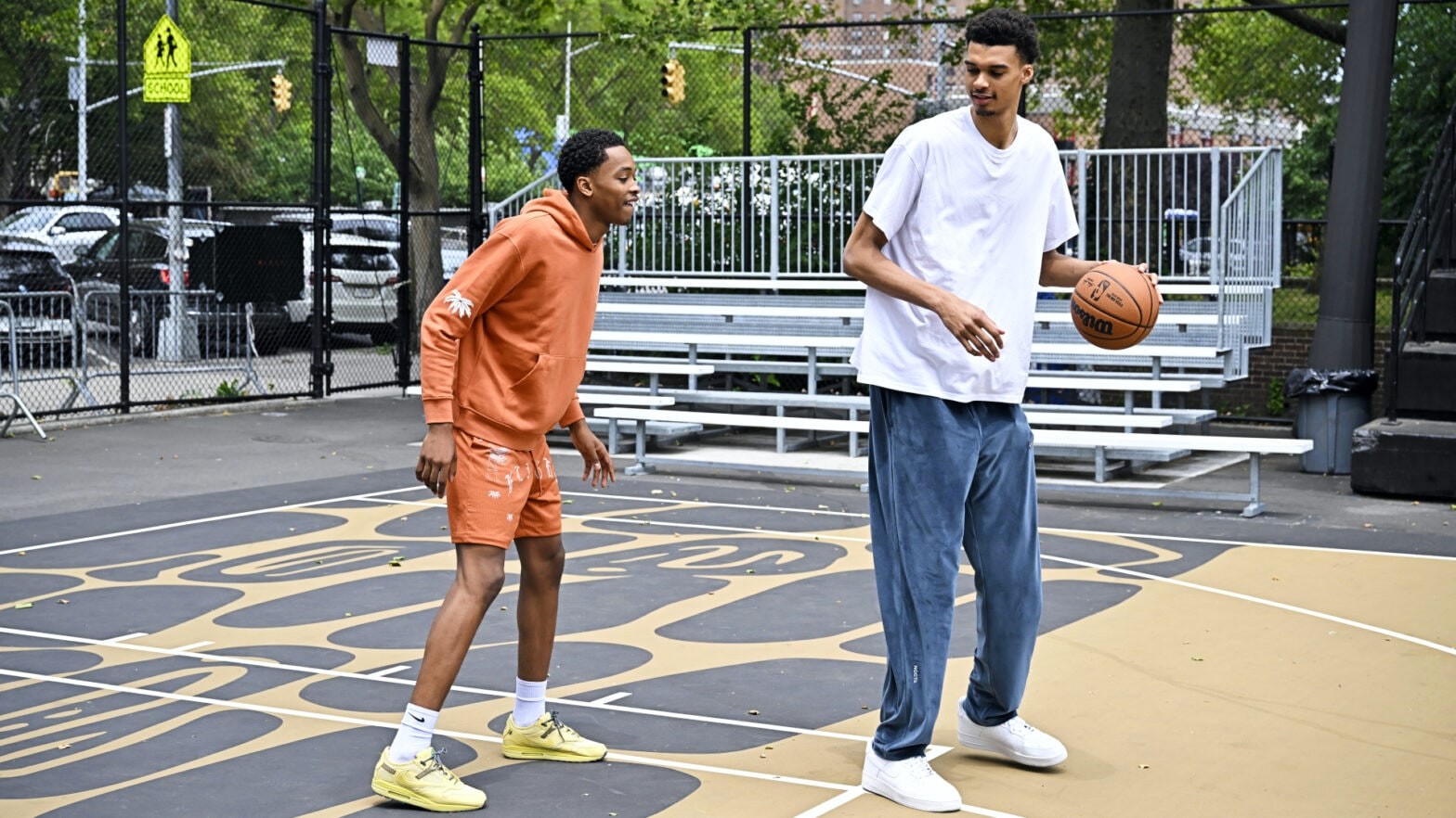 Victor Wembanyama and Bilal Coulibaly at Rucker Park, highlighting Wembanyama's exceptional height as he prepares to become the NBA's second tallest player.