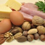 photo of an assortment of high-protein foods including cheese, eggs, fish, nuts