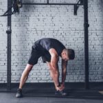 Person preparing for workout with creatine