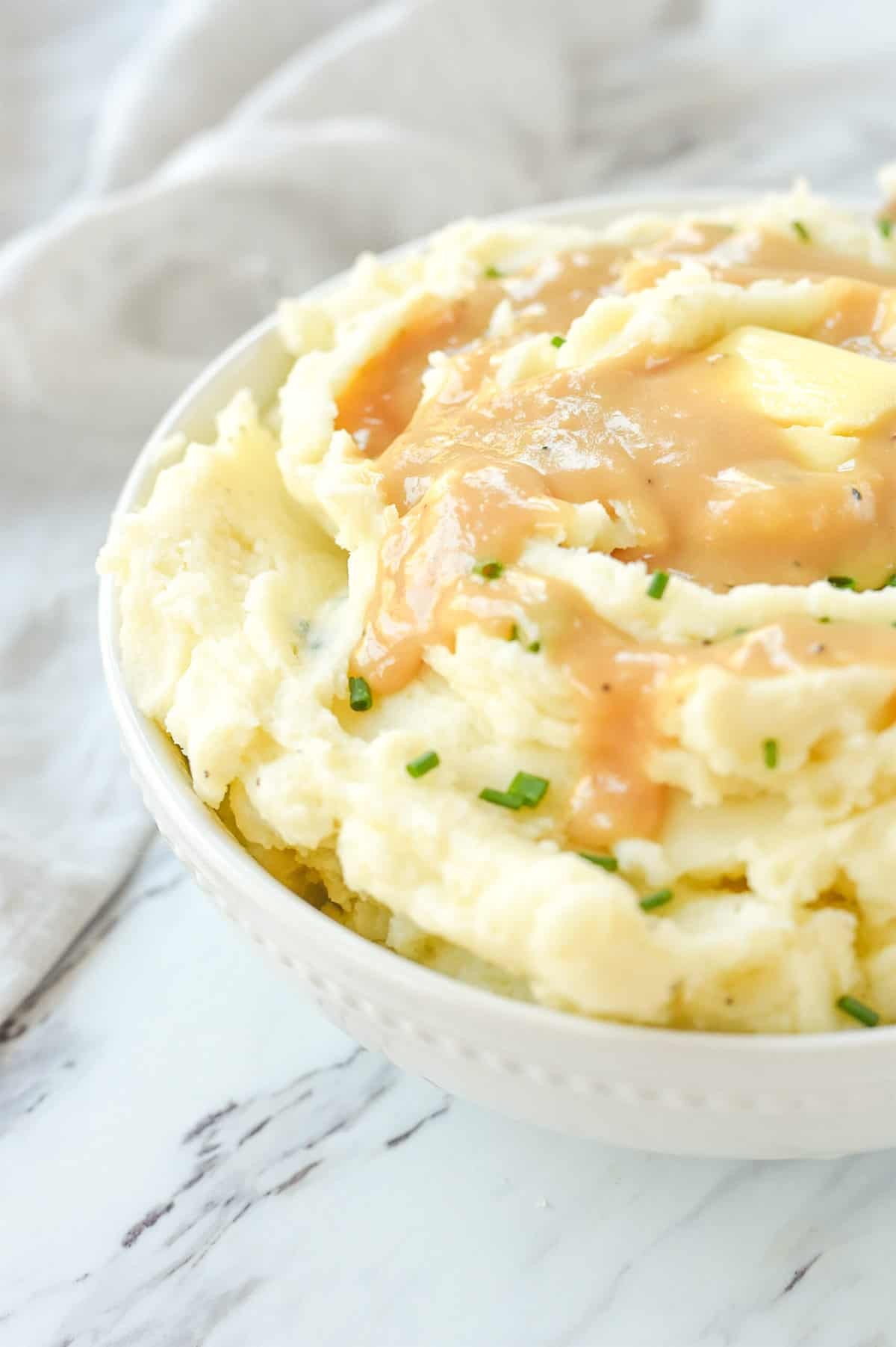 bowl of mashed potatoes with gravy on top