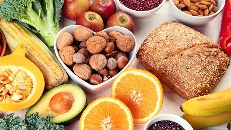 Variety of high fiber foods including fruits, vegetables, and whole grains that aid in relieving constipation and promoting healthy bowel movements.