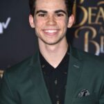 Cameron Boyce in suit smiling at camera.