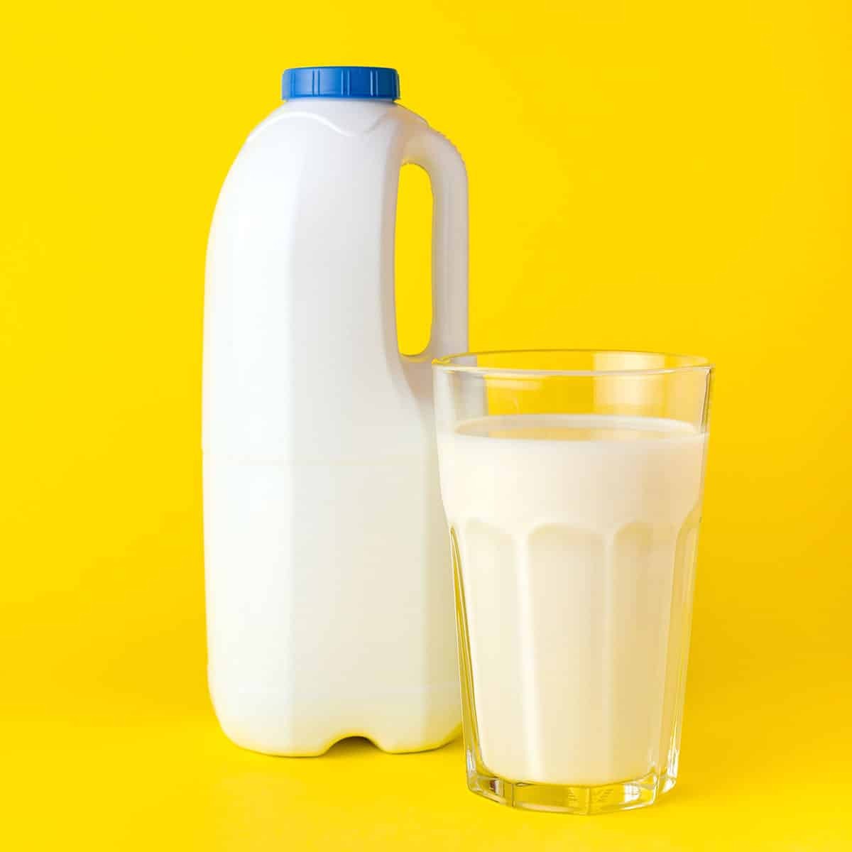 A container of milk, visually representing a quart, a standard unit of liquid volume in the Imperial system, contrasted against a bright yellow background.