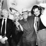 Truman Capote at Studio 54 in 1979 with Jerry Hall, Andy Warhol, Debbie Harry, and Paloma Picasso, reflecting his lifestyle of fame and excess that contributed to his declining health and eventual death from liver disease and drug intoxication.