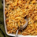 Classic green bean casserole with golden brown crispy onions on top.