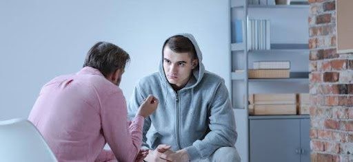 Two men in conversation, illustrating peer support during Suboxone treatment for opioid dependence.