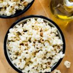 Close-up of popcorn popping in a pot on the stove, demonstrating how to make popcorn on the stove.