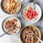 Variety of oatmeal bowls with different toppings like fruits and nuts