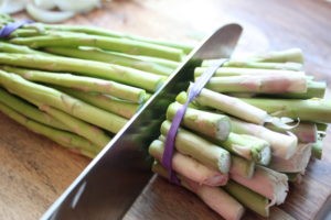 Fresh asparagus spears prepared for roasting, showcasing their vibrant green color and trimmed ends.