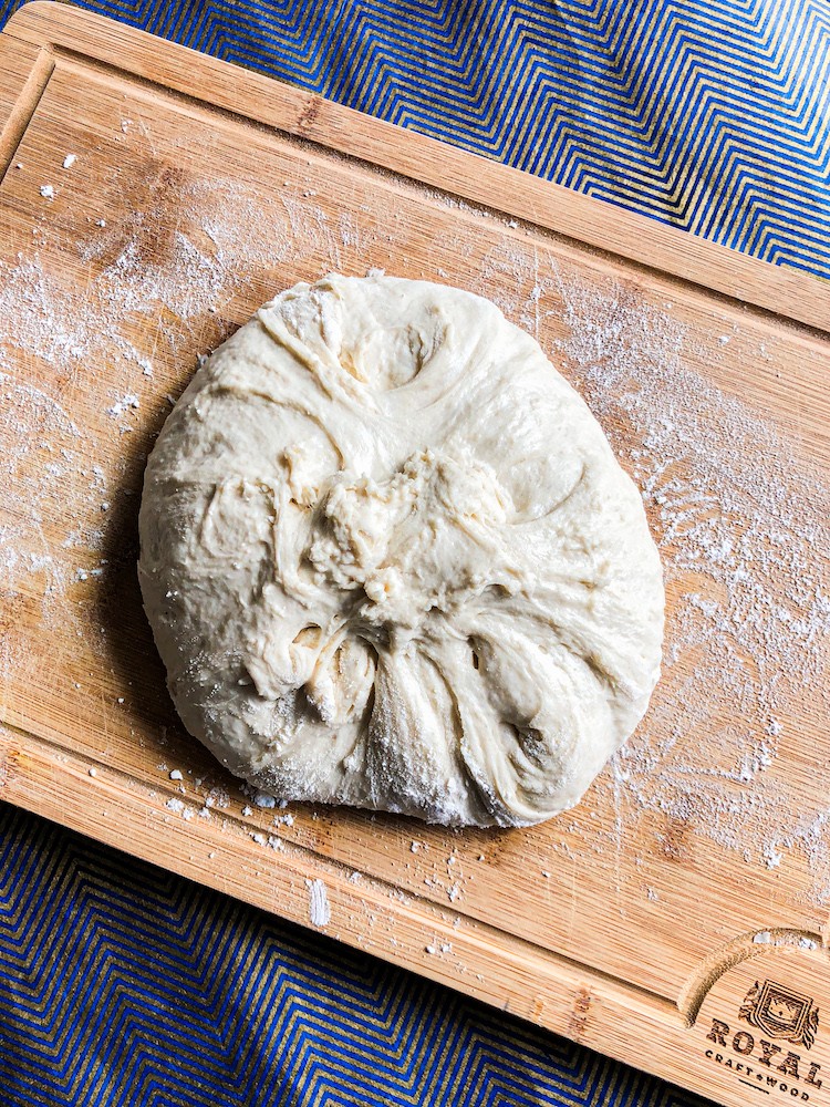 Close-up shot of freshly baked homemade bread loaf, showcasing its golden crust and soft interior.