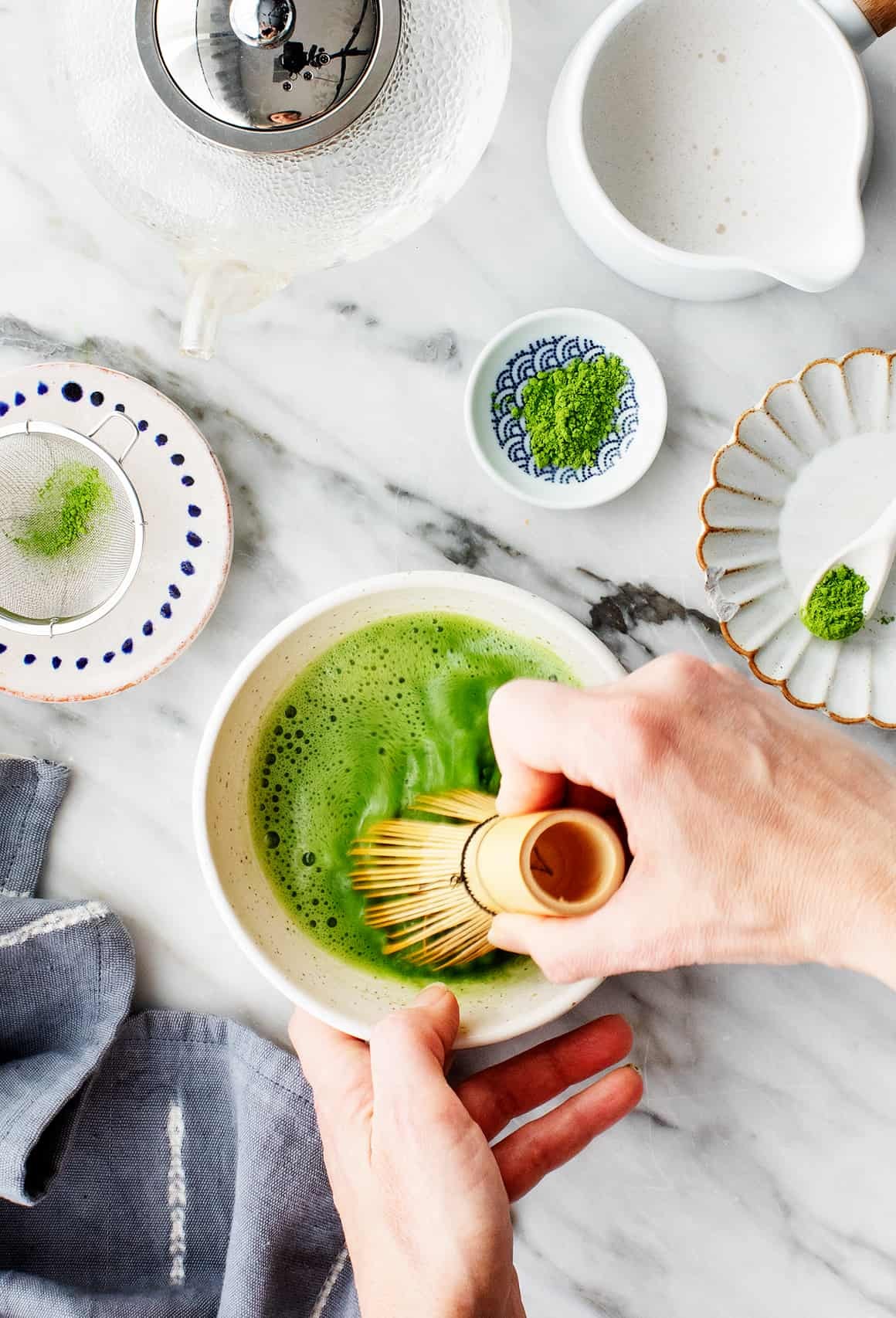 Vibrant cup of matcha green tea, showcasing its bright green color and frothy texture.