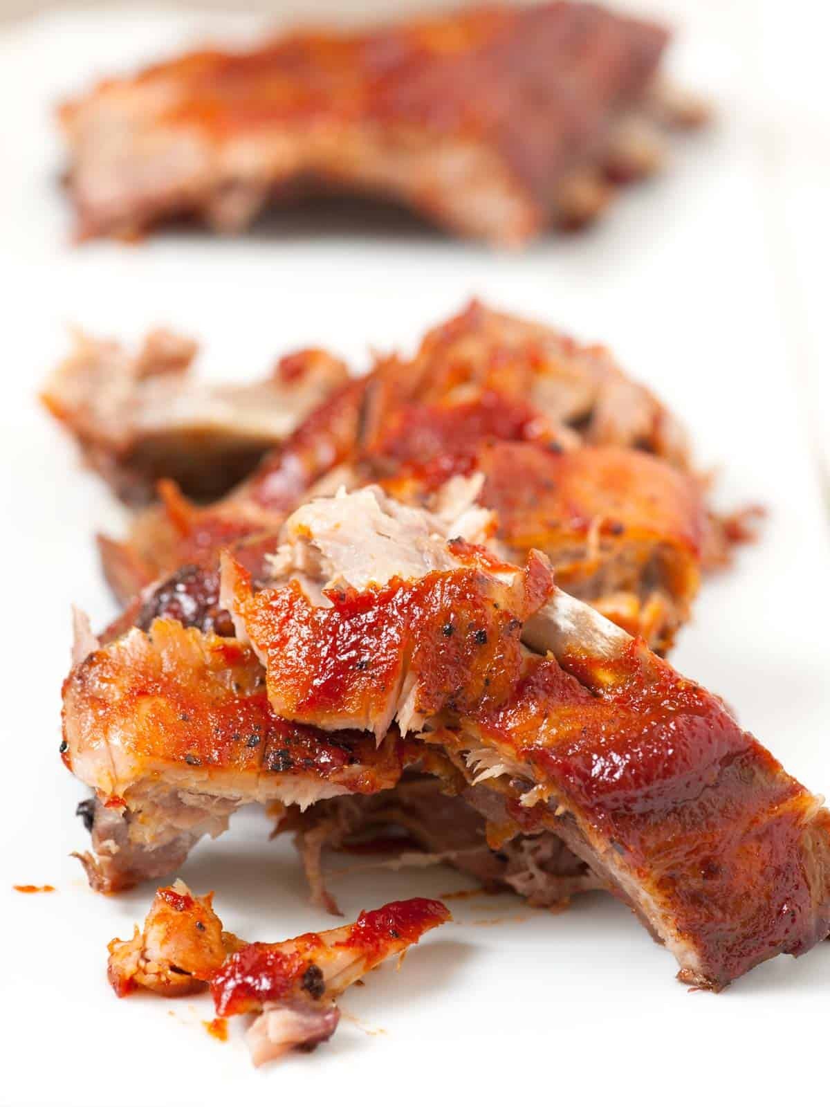 Close-up of tender oven-baked ribs, showcasing their juicy and fall-off-the-bone texture.