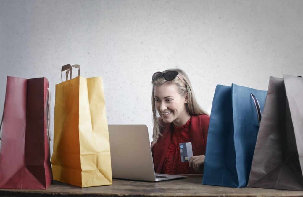 Woman happily unboxing Amazon packages at home, representing the joy of being an Amazon Vine reviewer.