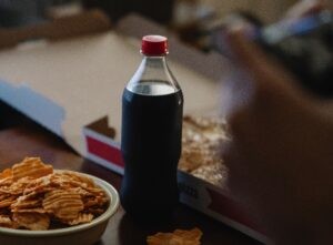 Selection of sugary drinks, pizza and chips