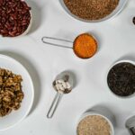 Assortment of vibrant spices and dried goods in bowls, enhancing culinary appeal and measured portions