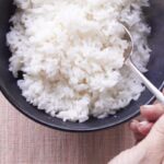 Bowl of perfectly cooked white rice with a spoon