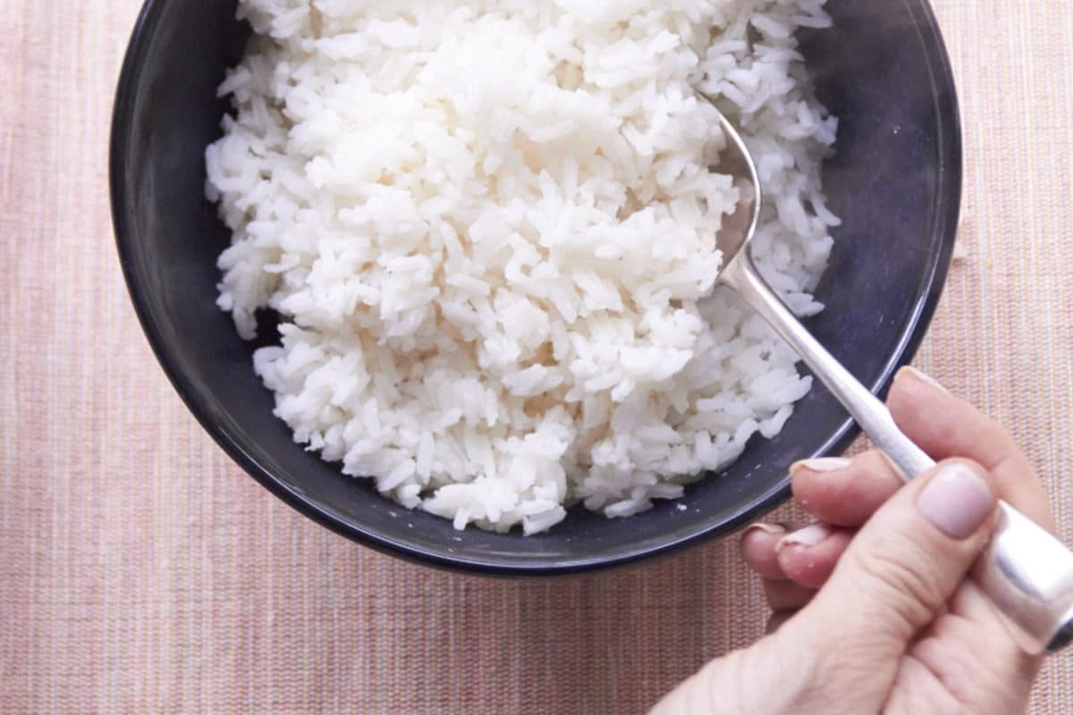 Bowl of perfectly cooked white rice with a spoon