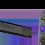 A Roku streaming stick plugged into a TV's HDMI port, with a simple Roku remote placed beside it, illustrating a compact and user-friendly streaming setup.