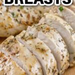 Close-up of juicy oven-baked chicken breasts seasoned with herbs and spices.