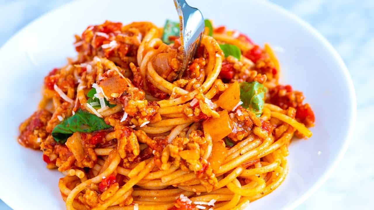 Close-up of spaghetti with meat sauce, showcasing the texture and richness of the sauce