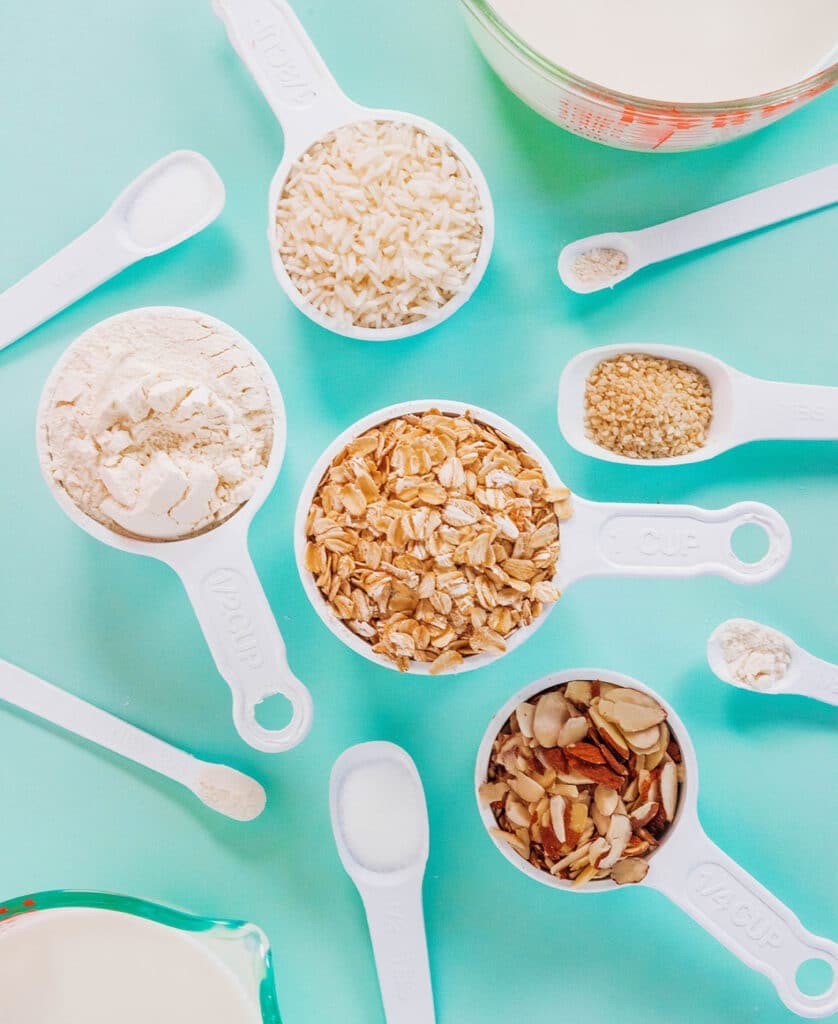 Conversion of tablespoons to cups shown with measuring cups and spoons filled with cooking ingredients, illustrating kitchen measurement tools.