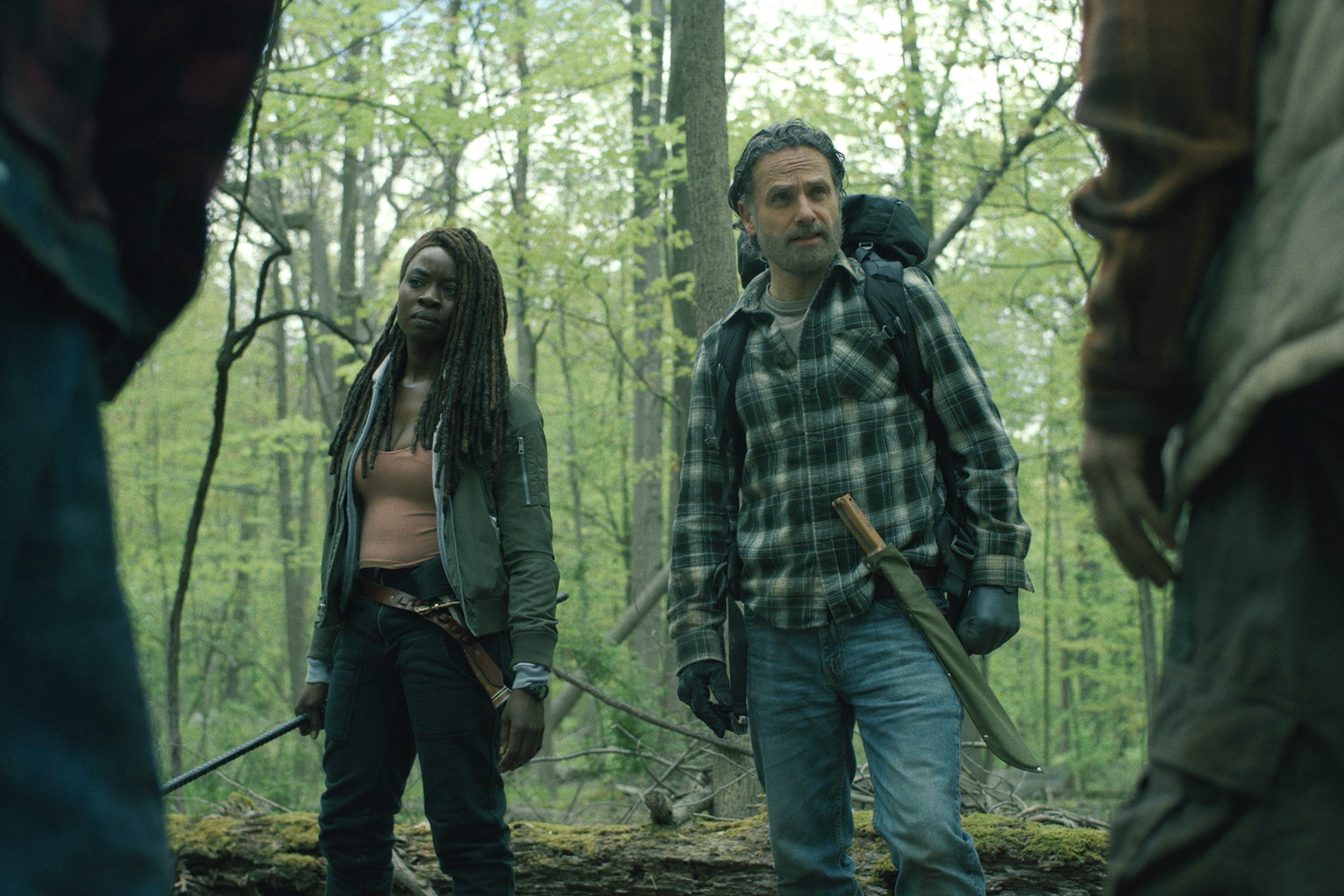 Michonne and Rick Grimes stand armed in a forest in The Walking Dead: The Ones Who Live