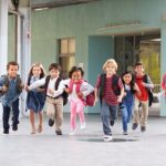 Kids running to elementary school