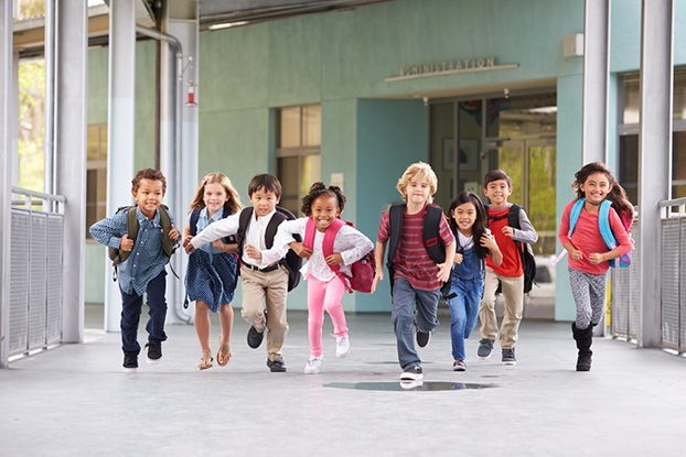 Kids running to elementary school