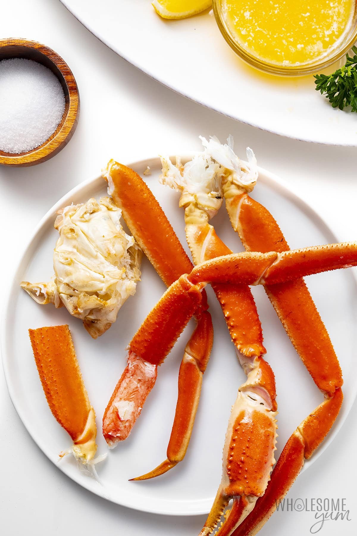 Showing how to eat crab legs, removing the meat from the shell.