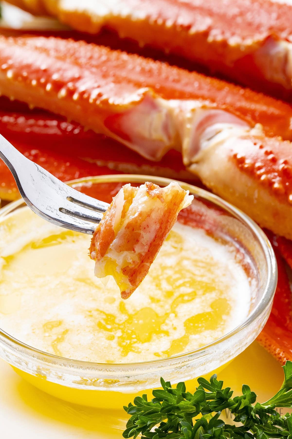 Crab meat dunked in melted butter with a little fork.